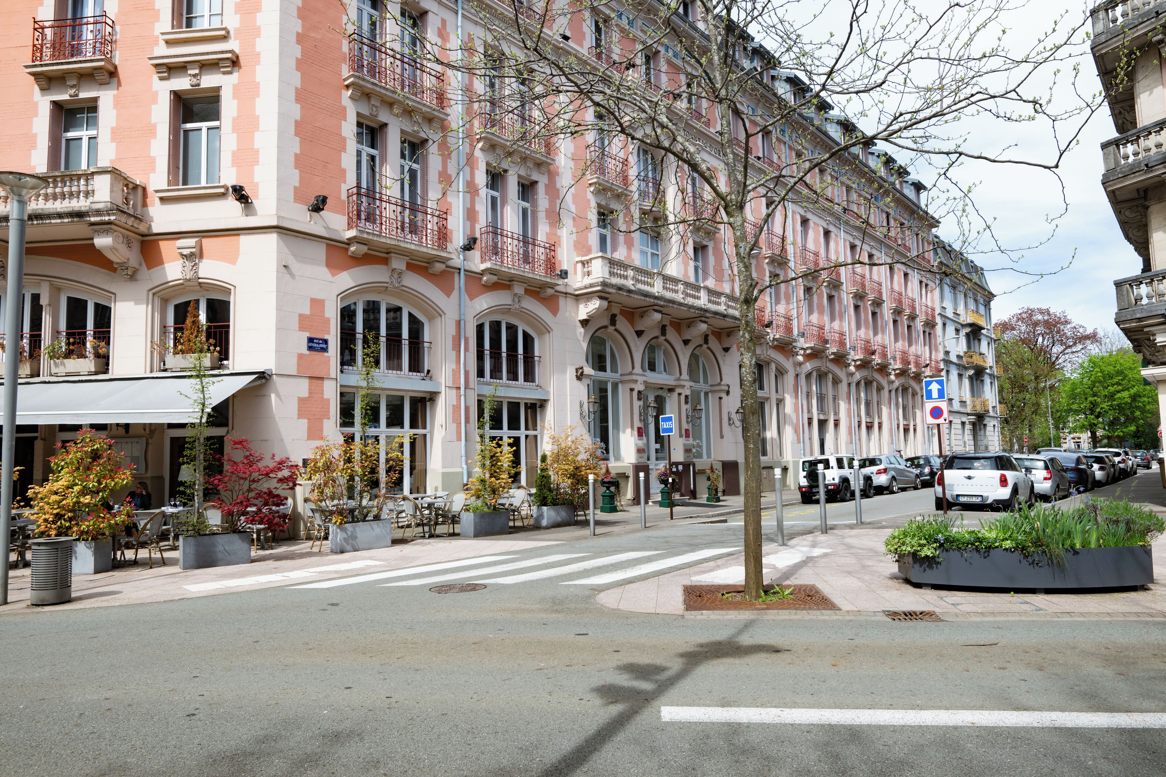 A multi-story building with a classic architectural style, featuring balconies and large windows.