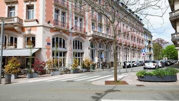 A multi-story building with a classic architectural style, featuring balconies and large windows.
