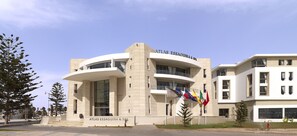 A modern building with a curved facade, labeled "Atlas Essaouira & Spa". - Atlas Essaouira Riad Resort (Essaouira)
