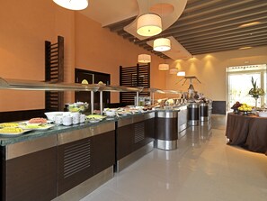 A buffet setup with various food items and a long counter.