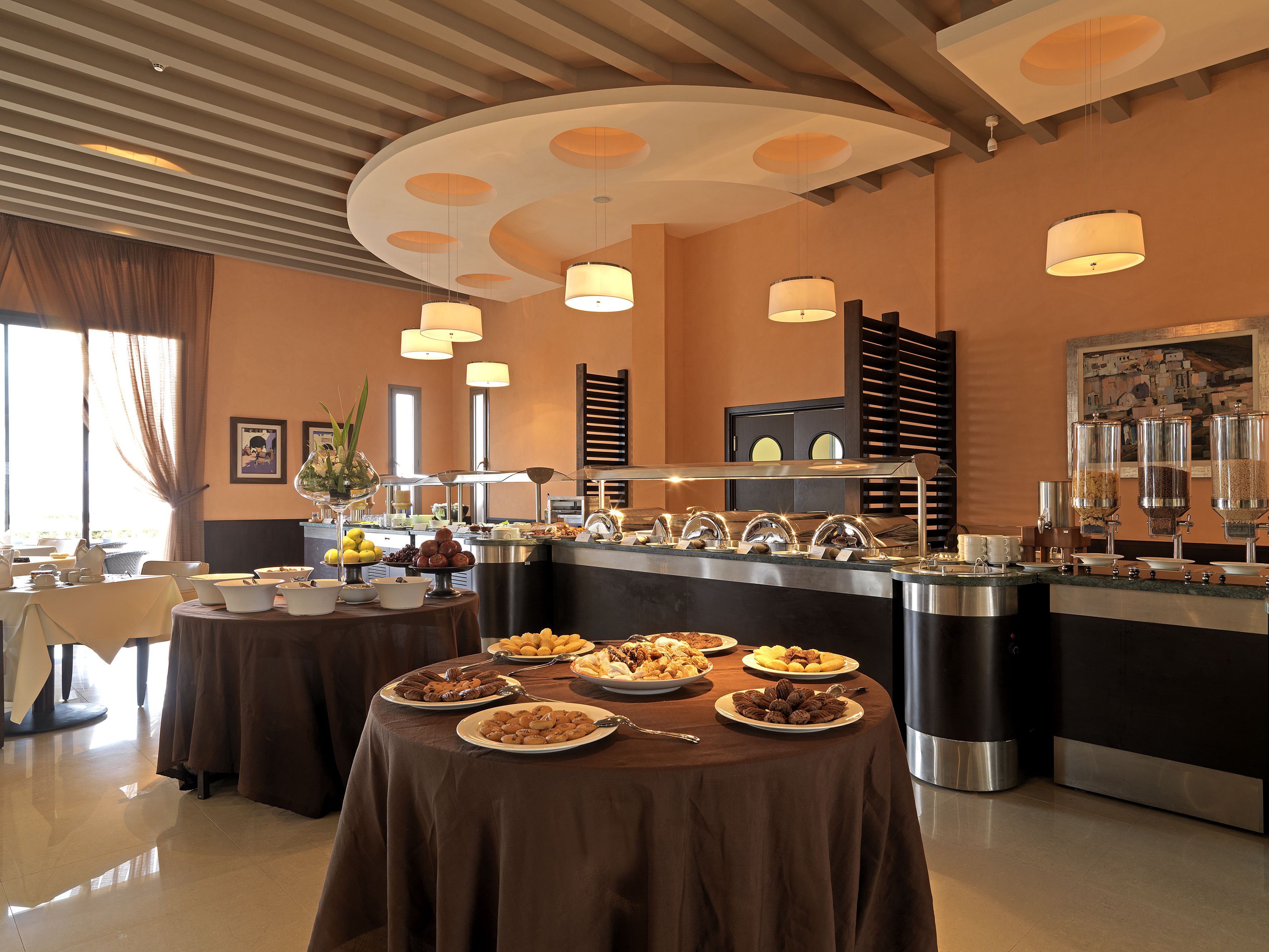 A buffet setup with multiple serving stations and a variety of food items.