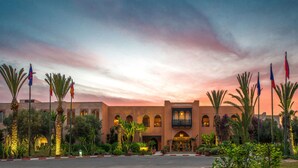 A hotel with a traditional architectural style, featuring arched windows and a central entrance. - Tikida Golf Palace (Inezgane)