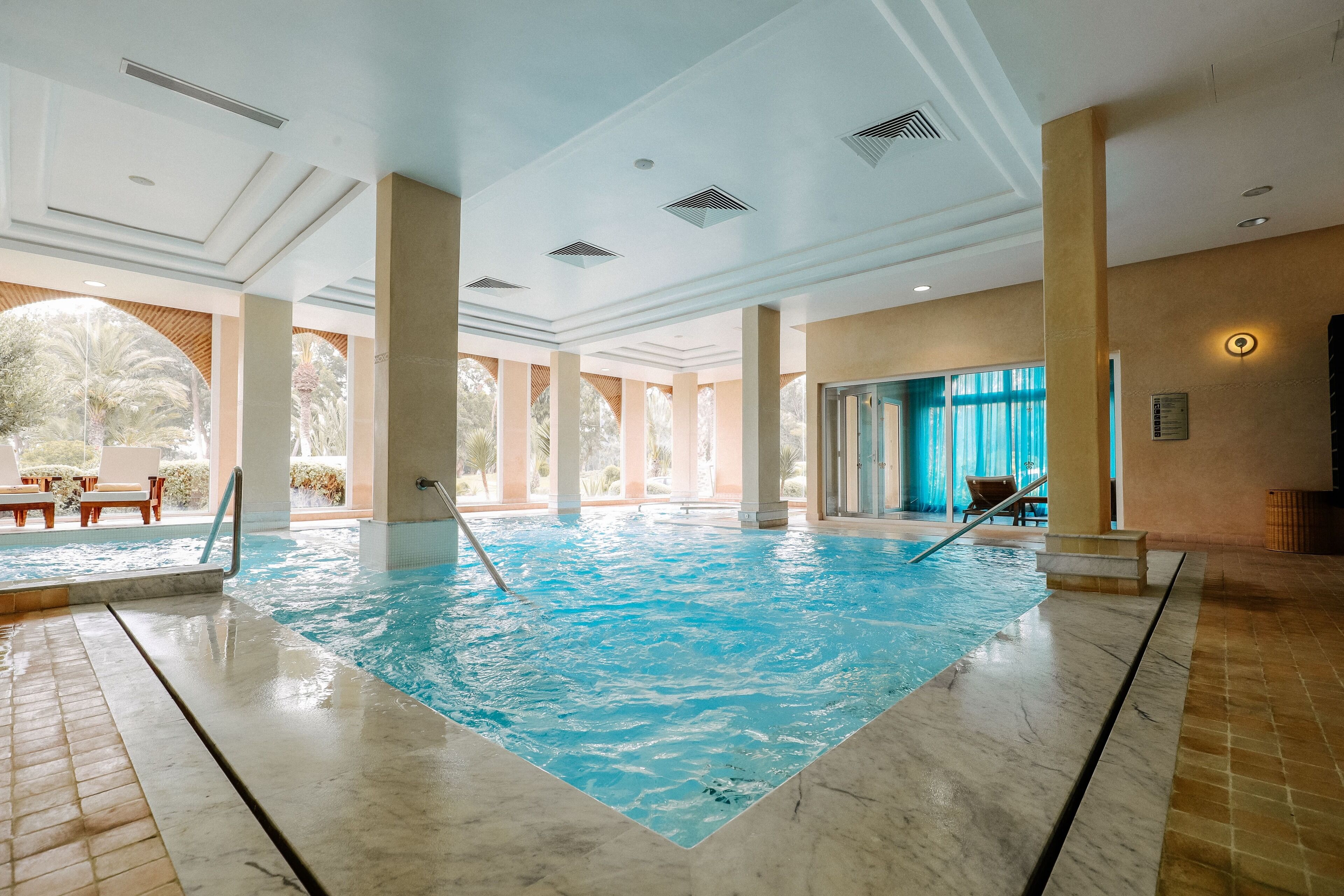 indoor pool, outdoor pool, pool umbrellas, pool loungers