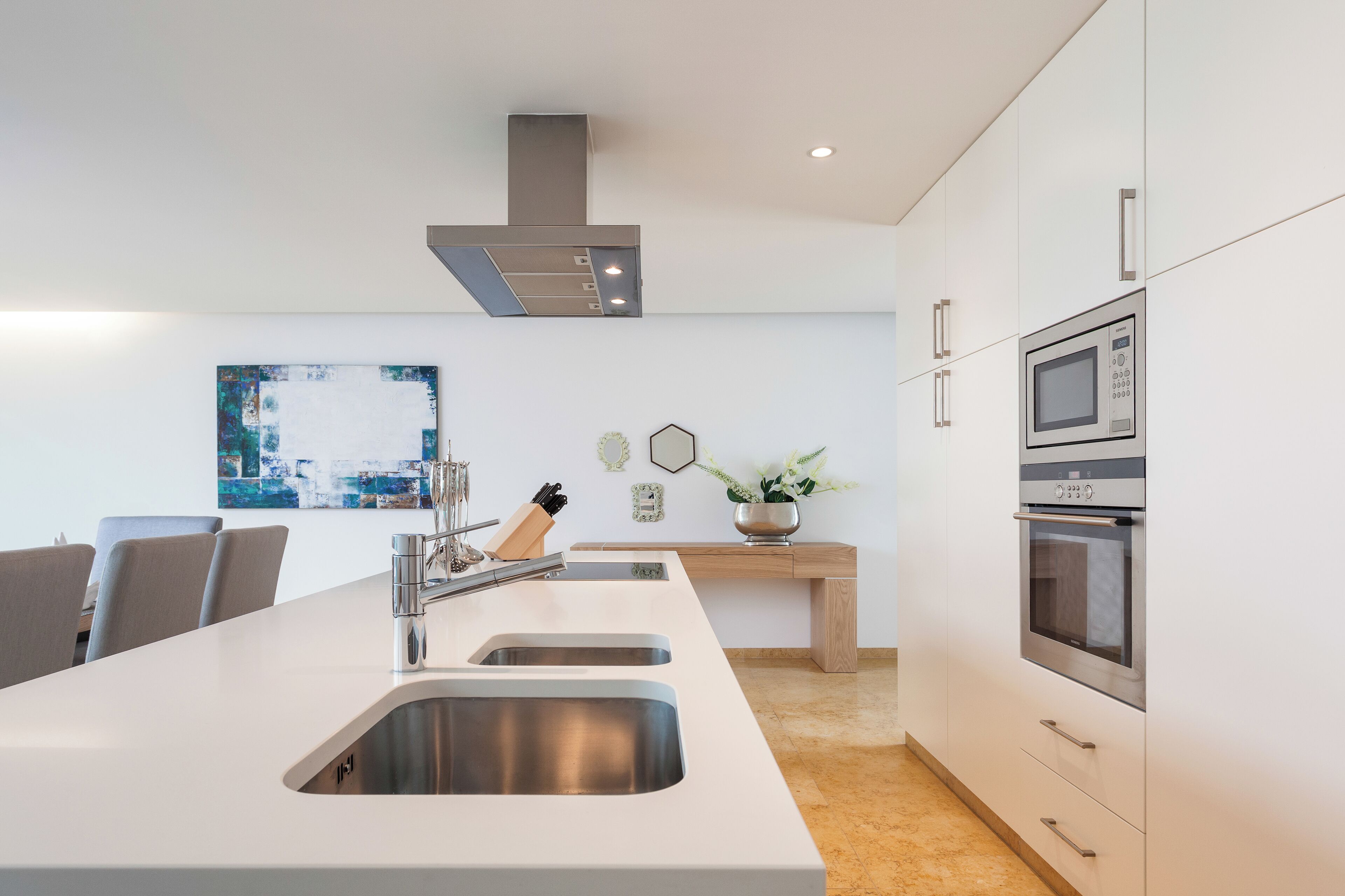 A modern kitchen with a central island, stainless steel appliances, and a minimalist design.