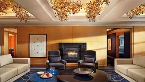 A modern lounge with two sofas, a fireplace, and a unique ceiling chandelier. - Mandarin Oriental, Boston (Boston)