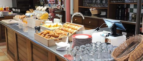 A buffet area with various food items, glassware, and a coffee machine.