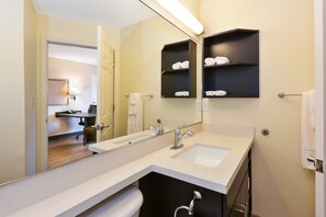 A modern bathroom with a double sink, a large mirror, and a towel rack. - Candlewood Suites Rocky Mount by IHG (Rocky Mount)