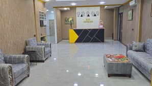 A reception area with a reception desk, two sofas, a coffee table, and a world map on the wall. - Baku Center inn (Baku)