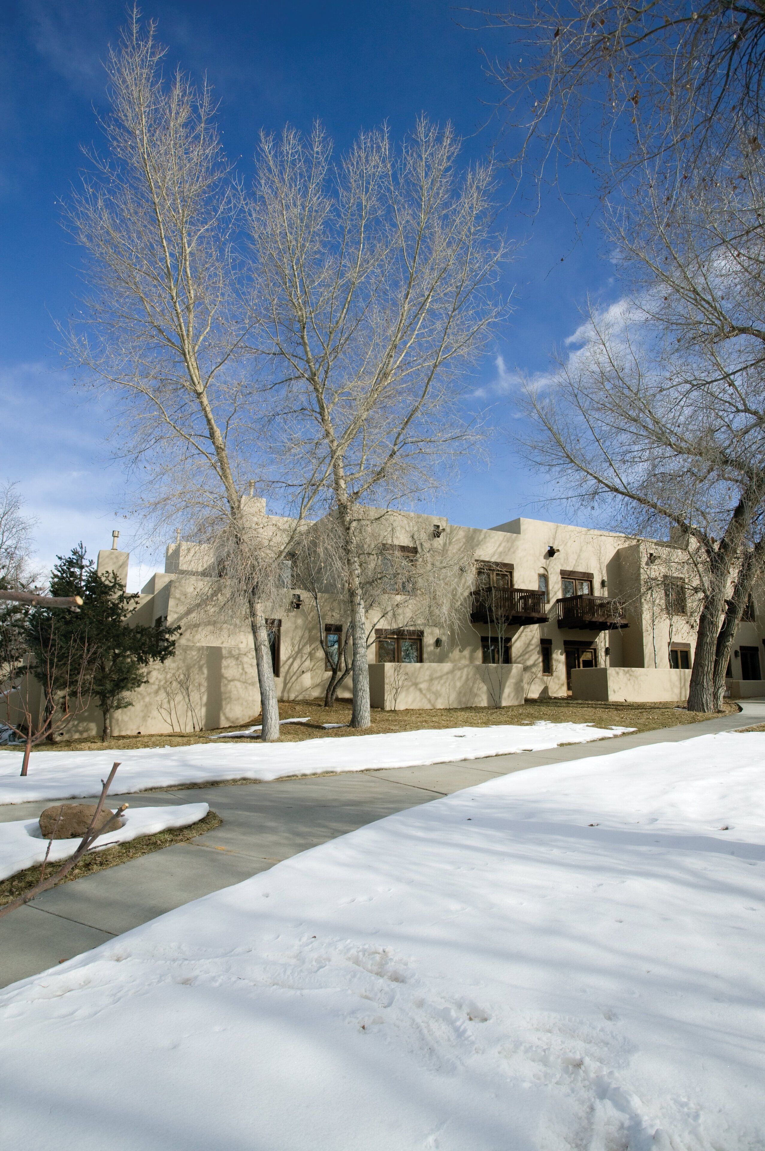 A building with a modern architectural style, featuring multiple balconies and large windows.