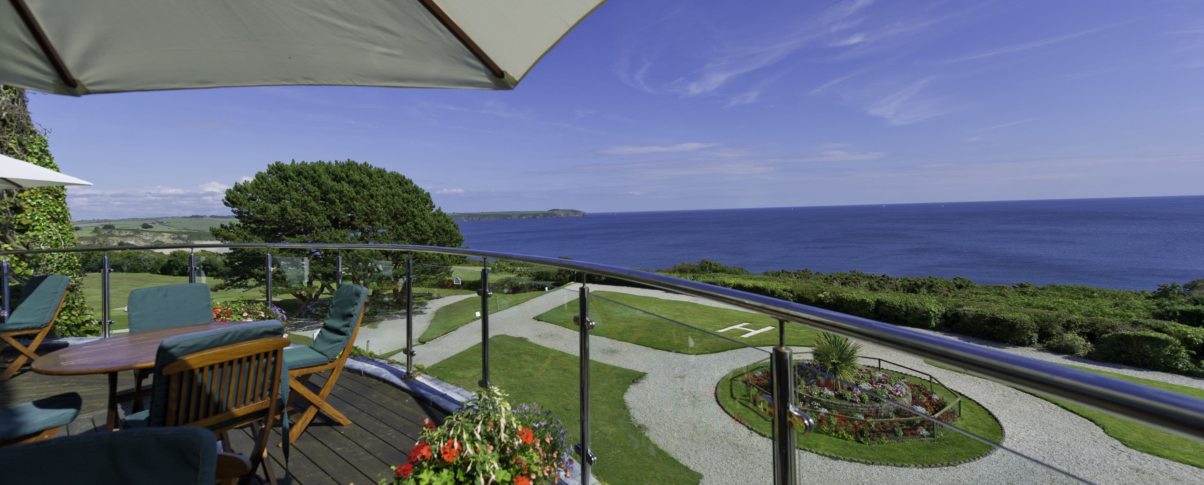 Una terraza con mobiliario exterior y vista al mar.