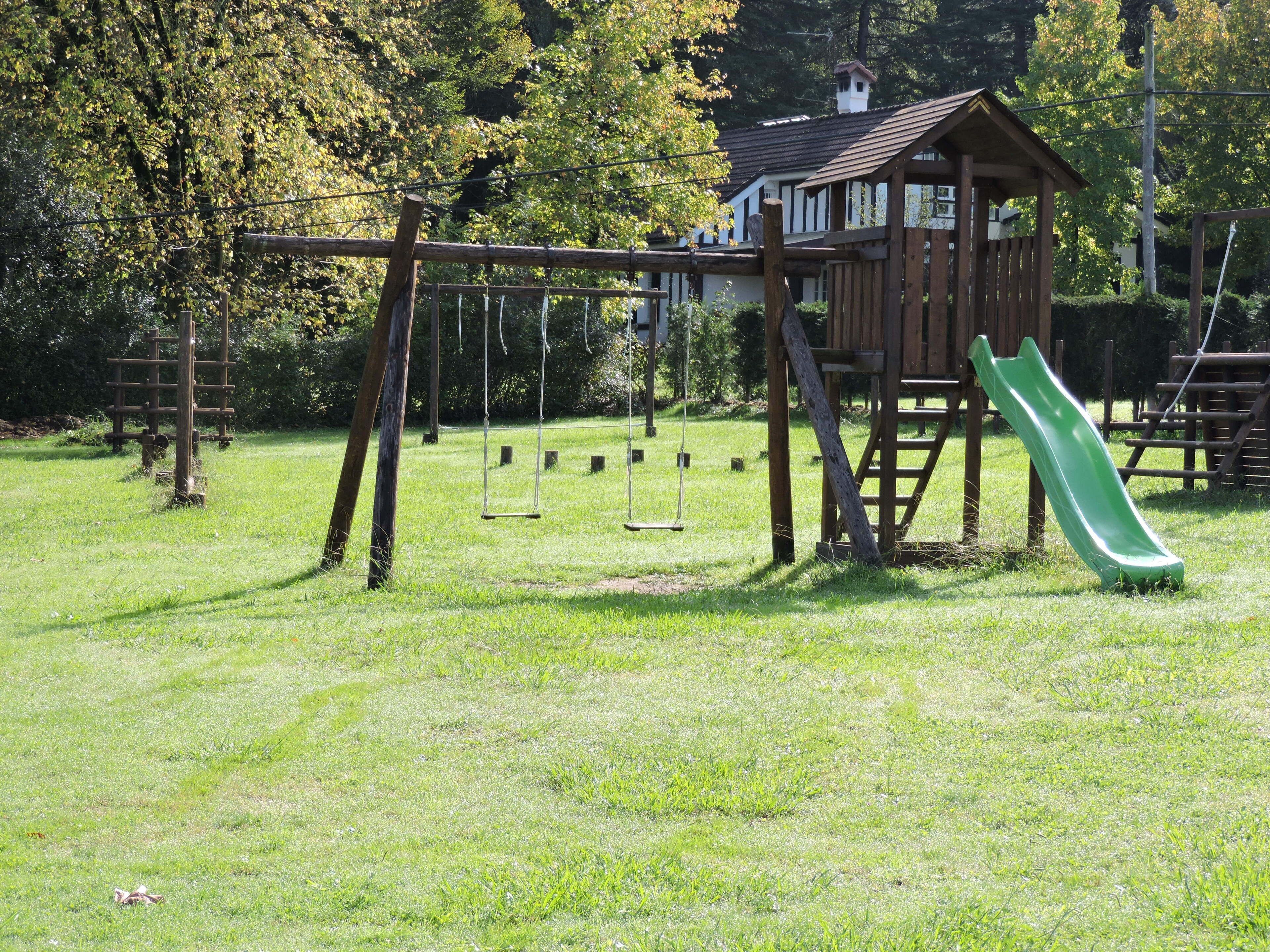 A playground with swings and a slide.