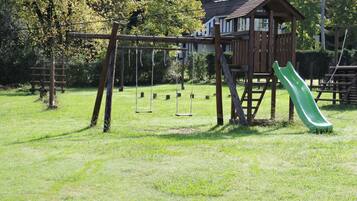 A playground with swings and a slide.