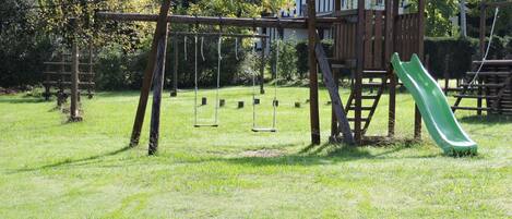 A playground with swings and a slide.