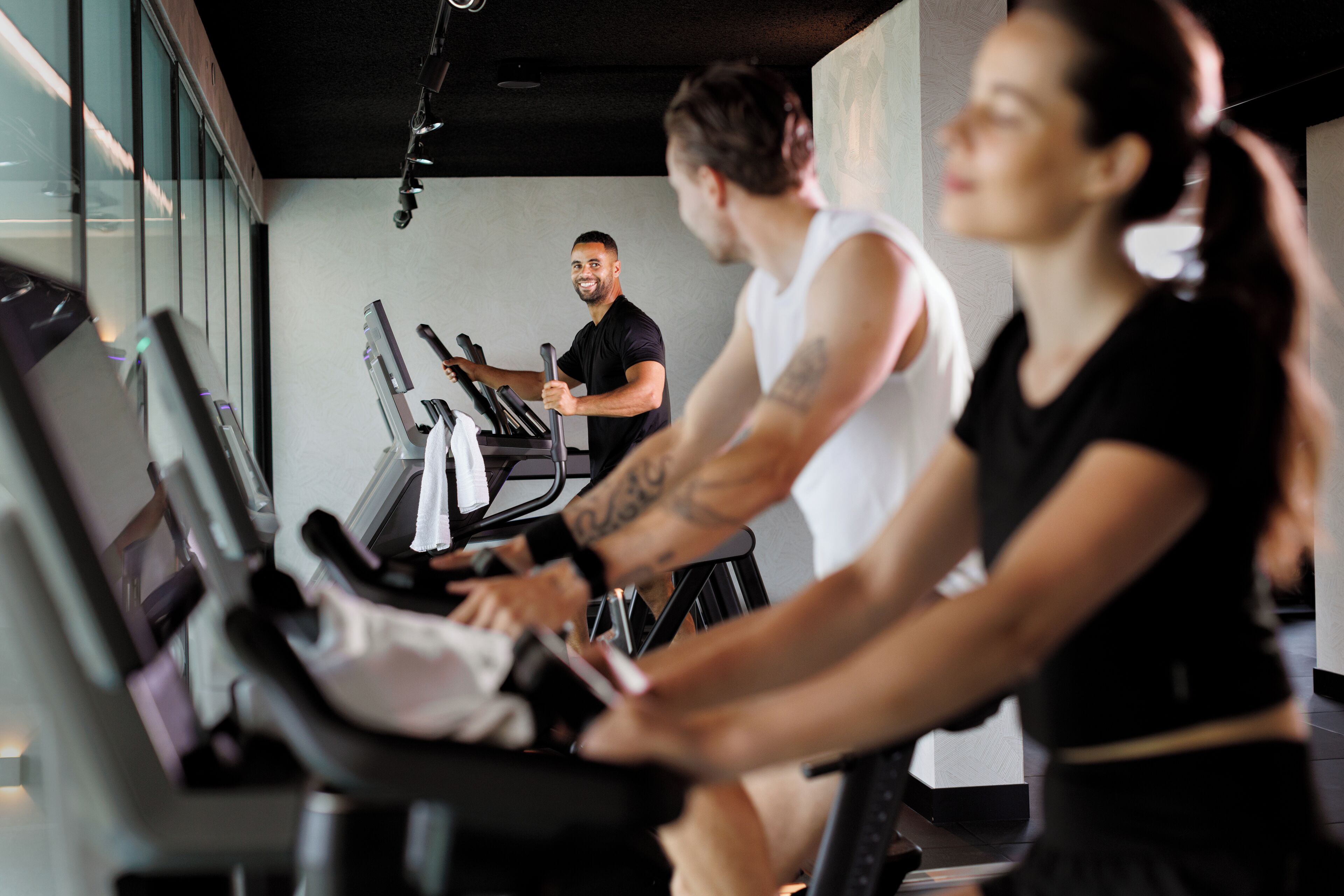 A gym with treadmills and stationary bikes.