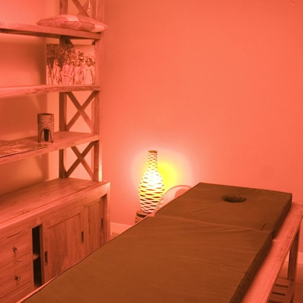 A room with a wooden table, shelves, and a hanging lamp.