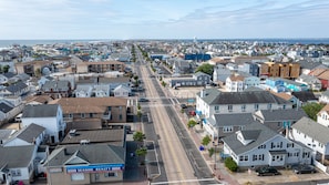 A coastal town with a mix of residential and commercial buildings, including a hotel with a visible sign.