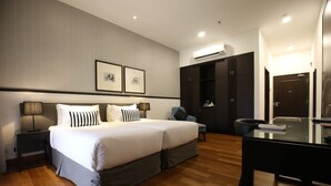 A hotel room with a large bed, a desk, and a wardrobe. - Pulai Springs Resort (Johor Bahru)