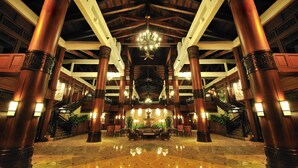 A spacious lobby with high ceilings, large wooden columns, a central chandelier, and a staircase leading to upper levels. - Pulai Springs Resort (Johor Bahru)