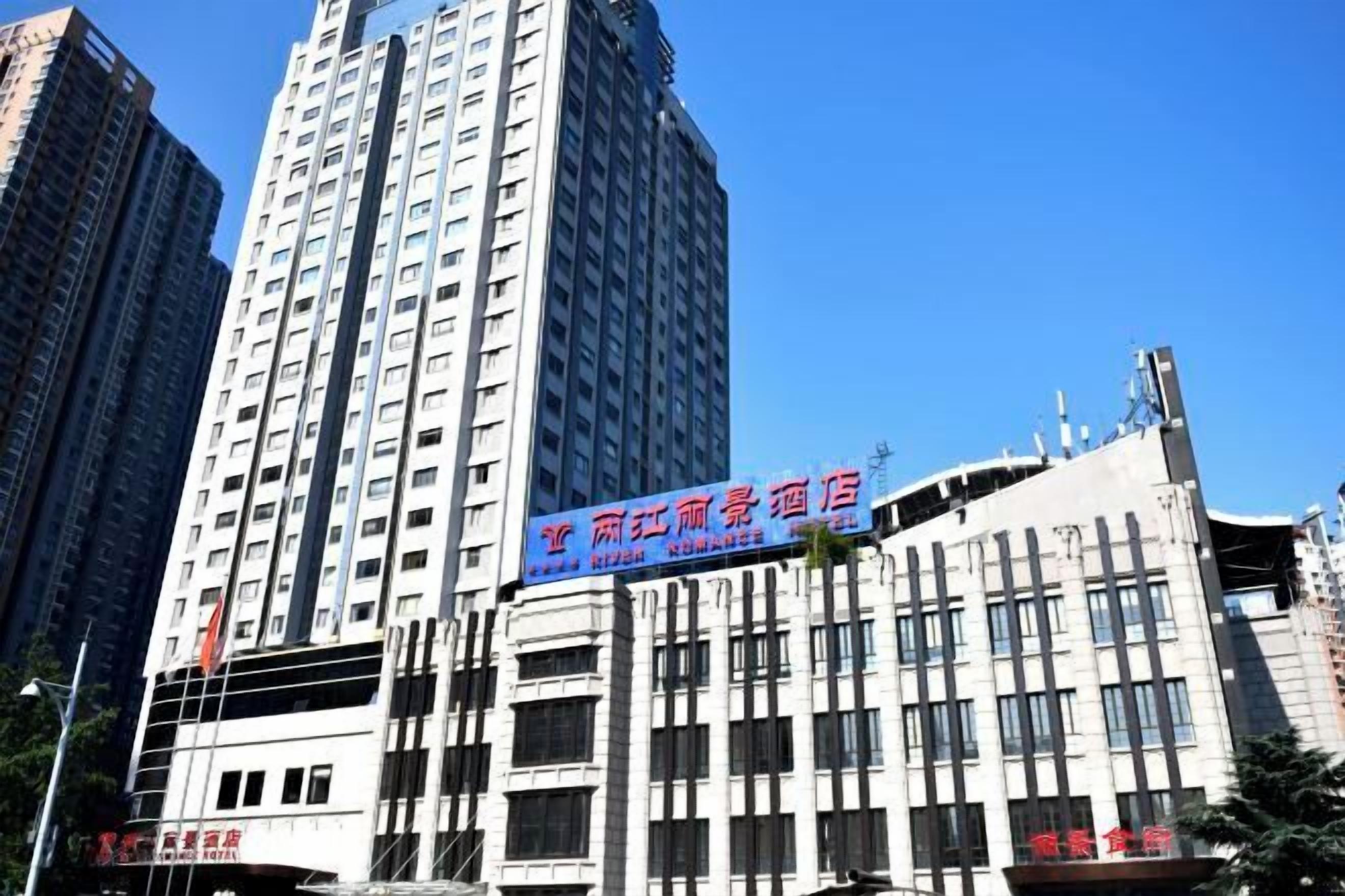 A multi-story hotel with a prominent blue sign advertising a restaurant.
