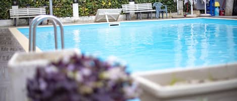 Seasonal outdoor pool, pool umbrellas, pool loungers