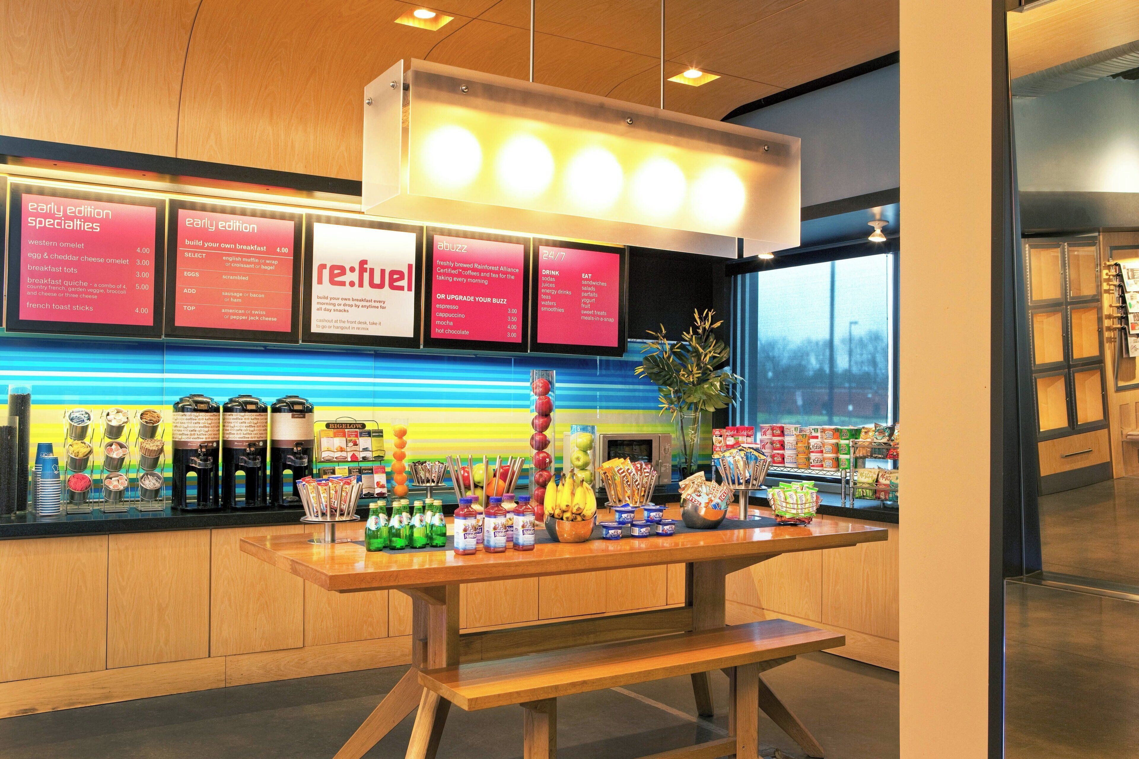 A breakfast bar with a menu board displaying breakfast options and a selection of beverages.