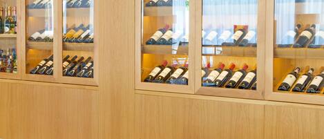A wine cellar with wooden shelves and a table with blue bowls.