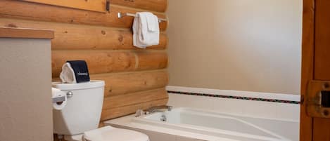 A bathroom with a toilet, sink, and bathtub.