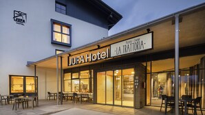 The JUFA Hotel exterior with outdoor seating and a visible entrance. - JUFA Hotel Wipptal (Steinach am Brenner)