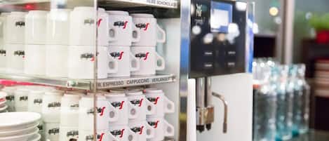 A coffee machine with labeled containers for different types of coffee and milk.