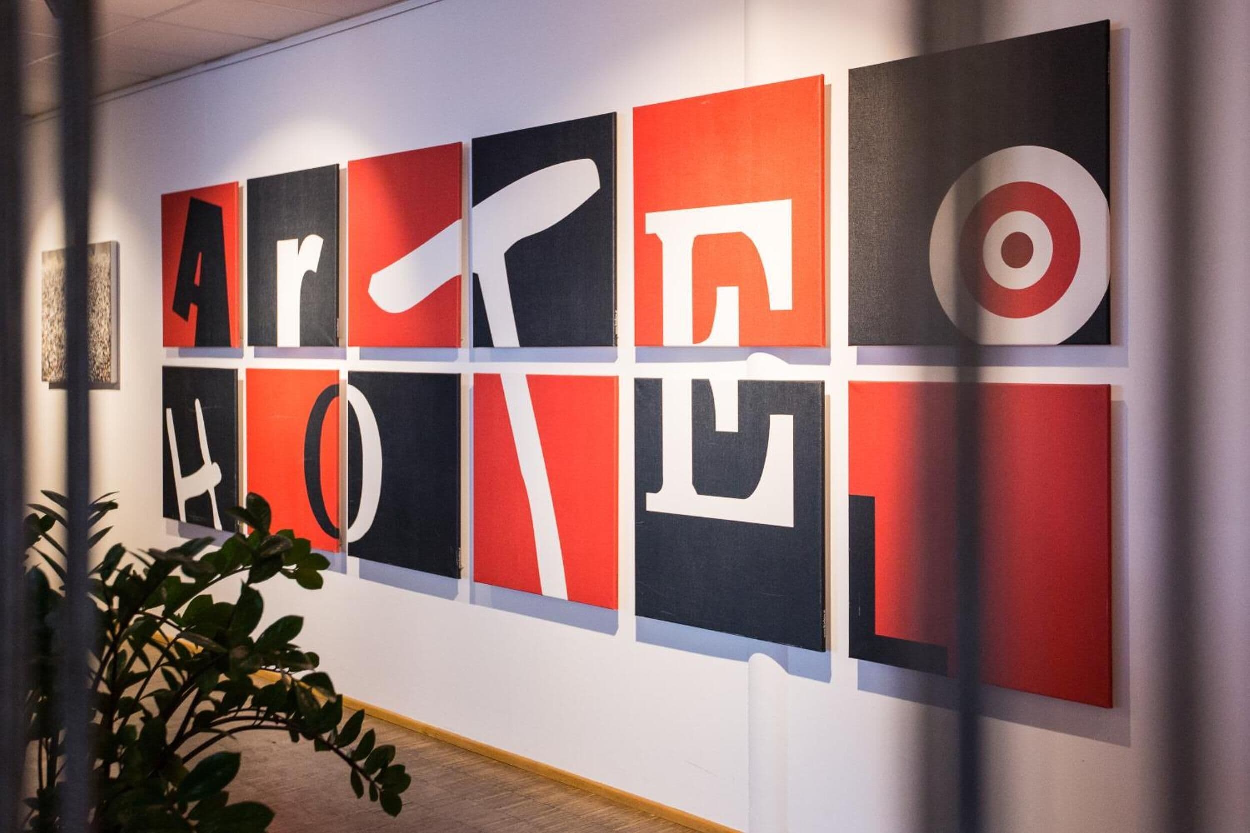 A wall with large, bold letters spelling "ARE LOVE" in a modern art style.