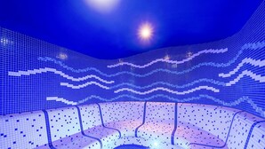 A blue-tiled room with a curved seating area and a central open space. - Quality Hotel Ostrava City (Ostrava)