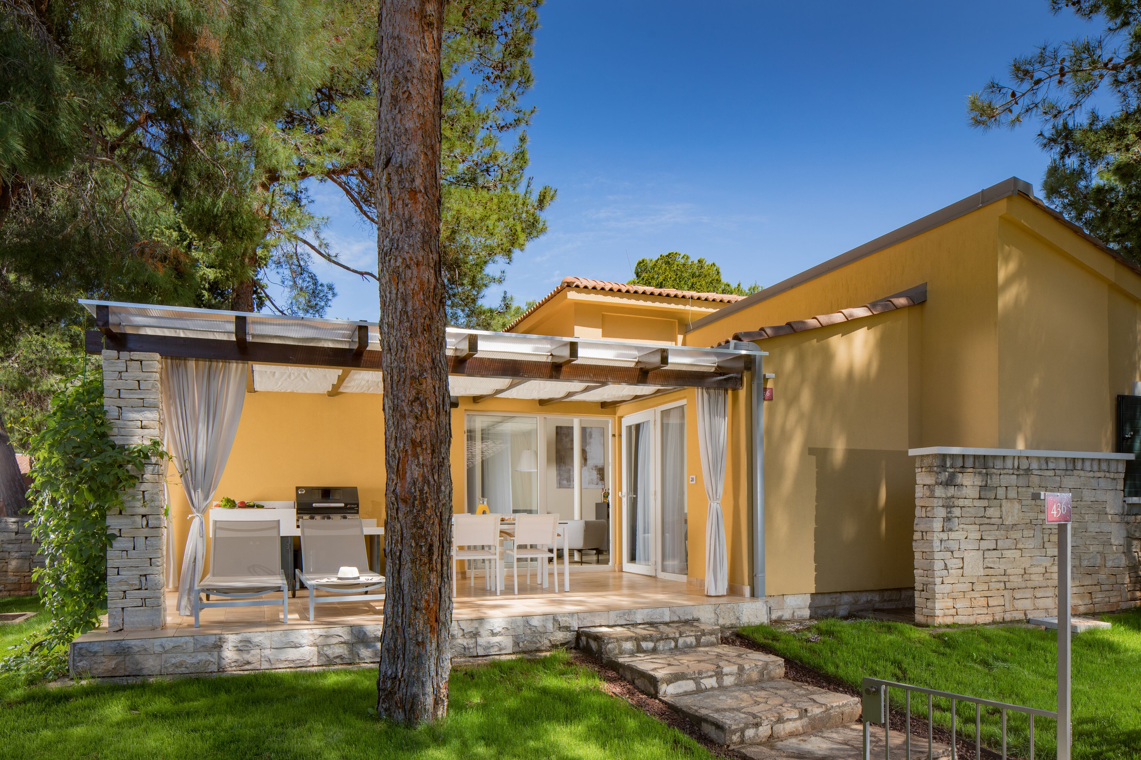 A house with a patio, a dining area, and a garage.