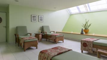 Relax in this serene room with a high ceiling, skylight, and comfortable seating area.