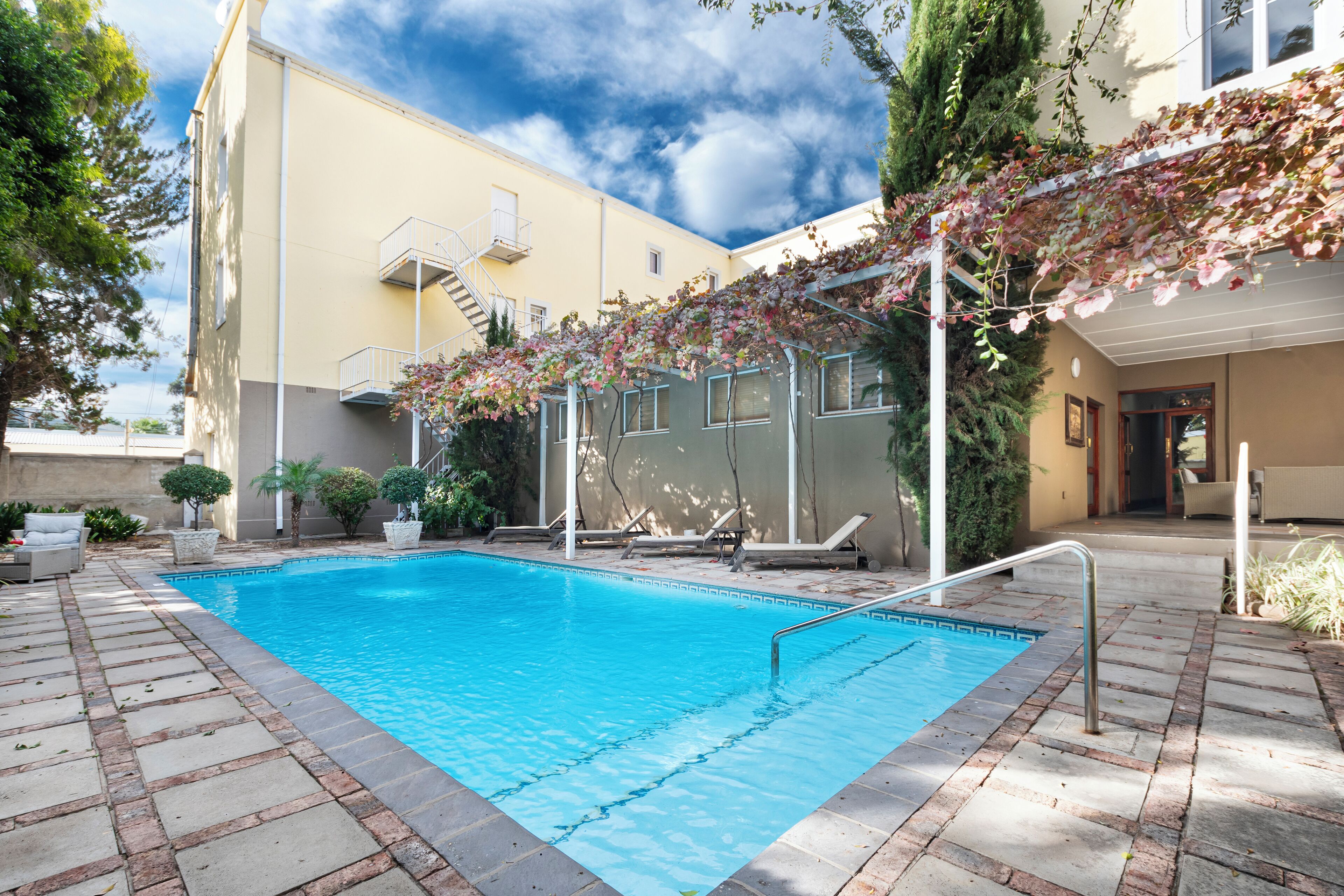 outdoor pool, pool umbrellas, pool loungers