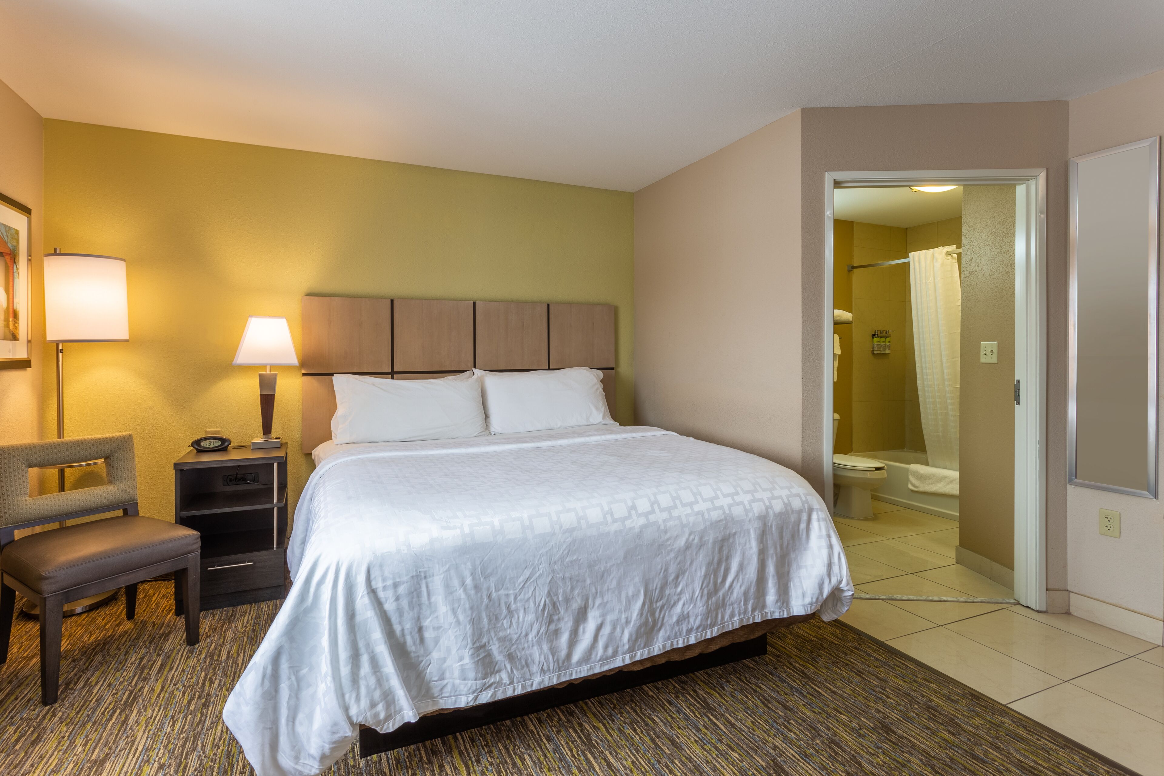 studio suite | premium bedding, desk, laptop workspace, blackout curtains