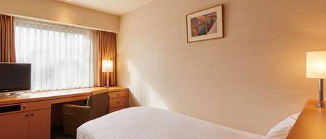 A hotel room with a bed, a desk with a chair, a television, and a painting on the wall.