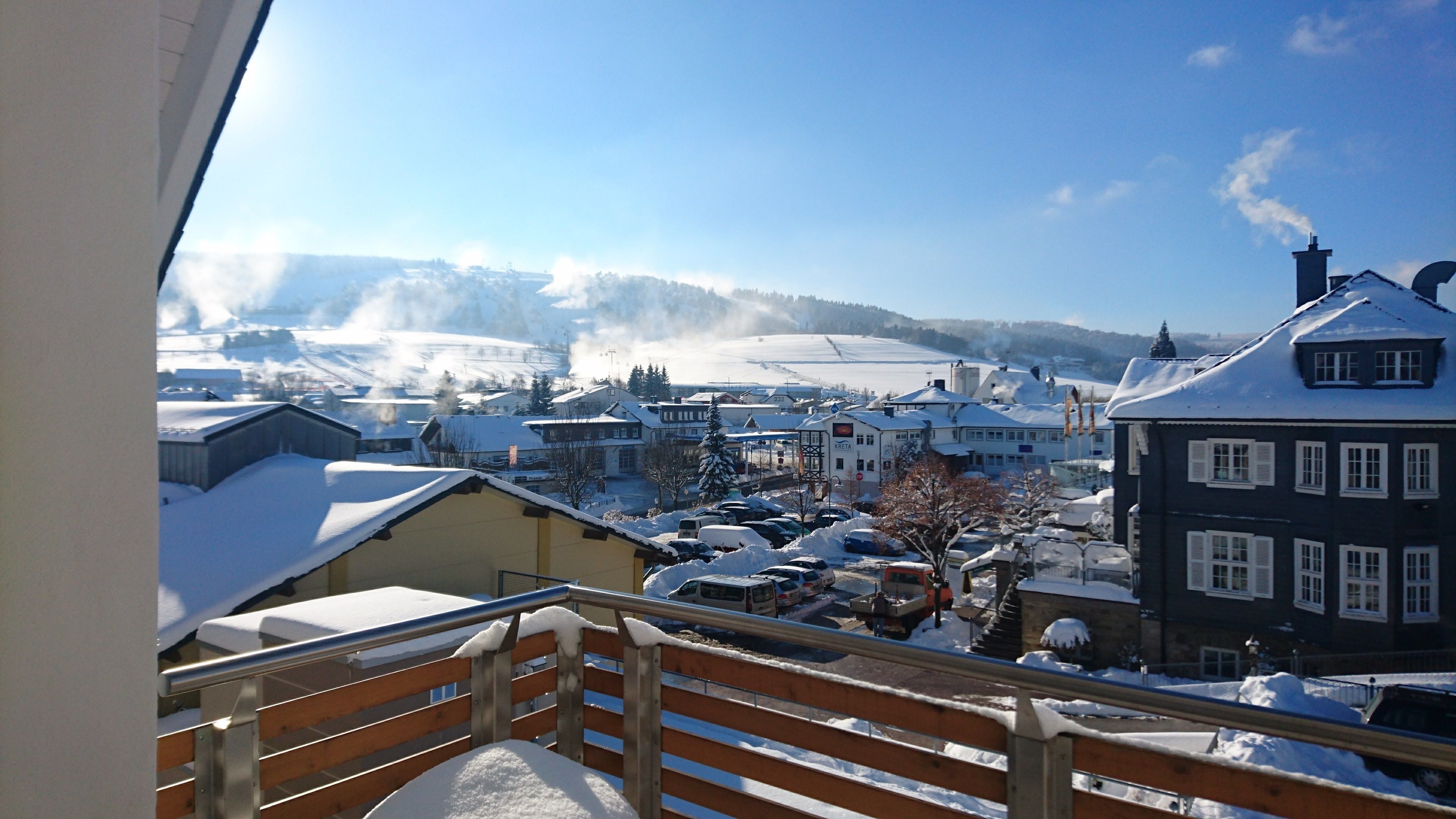 A snow-covered town with buildings and a clear sky.