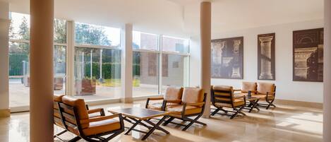 A spacious lobby with modern seating and large windows.