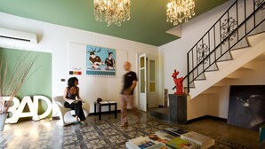 A lobby with a patterned floor, a staircase, a chandelier, and a door leading to another room. - Bad - Bed & Breakfast and Design (Catania)
