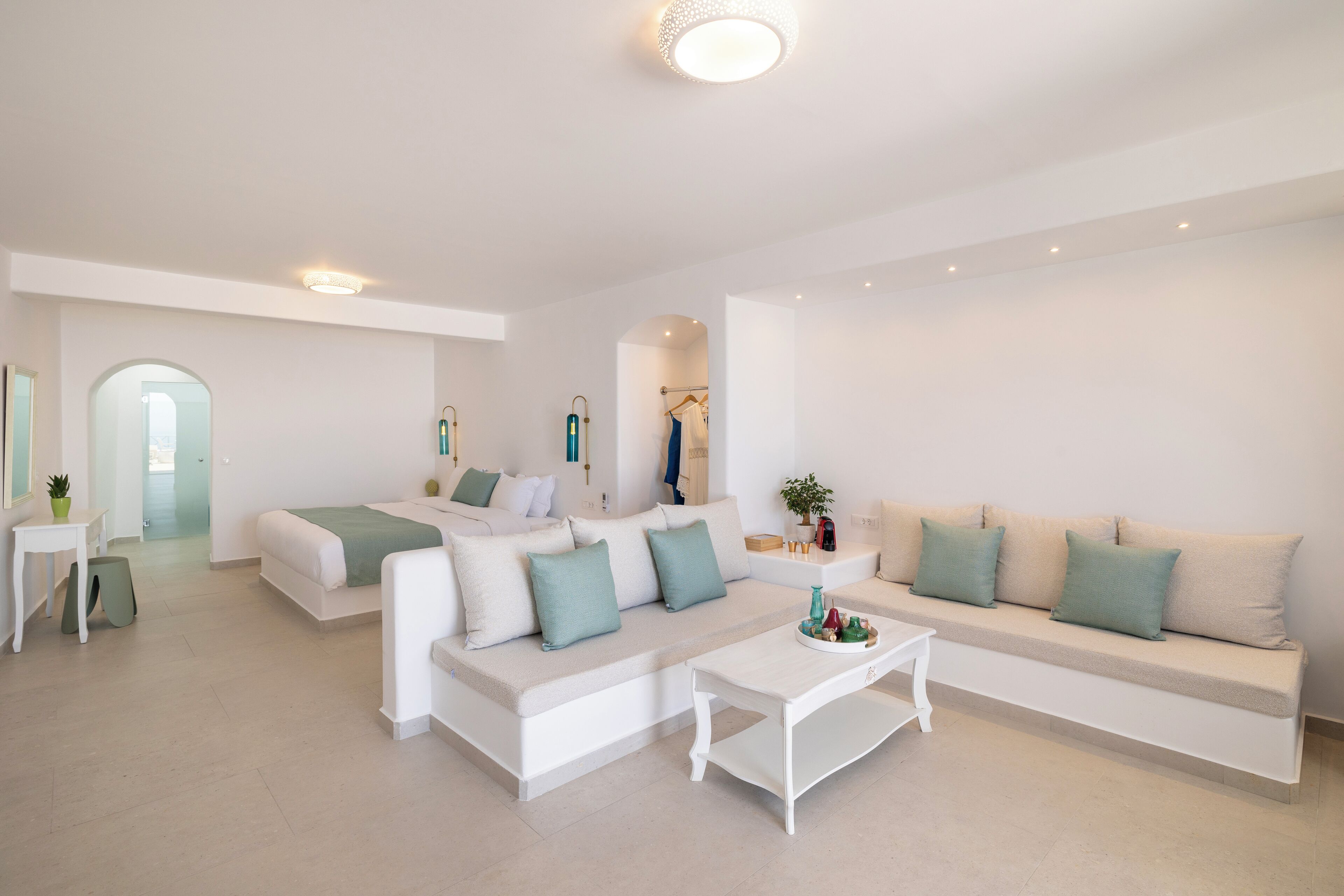 A modern living room with a sofa, a bed, and a coffee table.