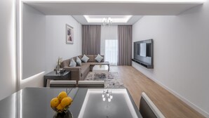 A modern living room with a sofa, coffee table, and TV.