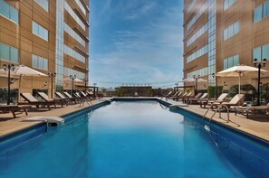 Outdoor pool, open 7:00 AM to 10:00 PM, pool umbrellas, sun loungers