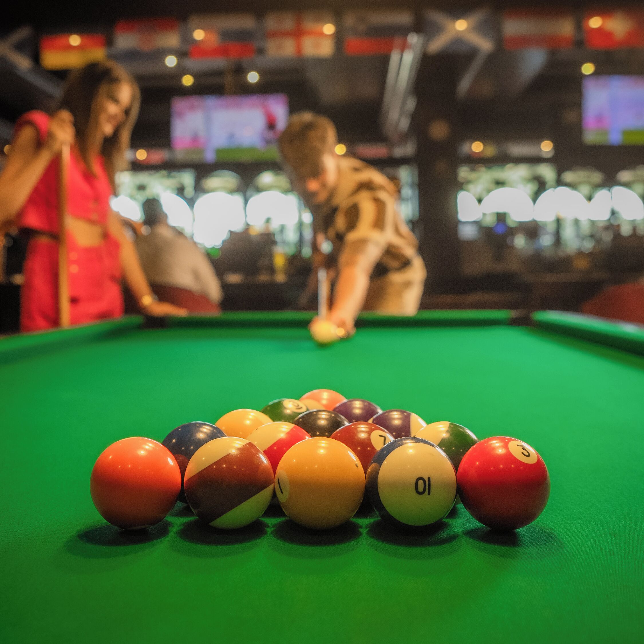 A pool table with balls arranged in a triangle.