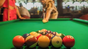A pool table with balls arranged in a triangle.