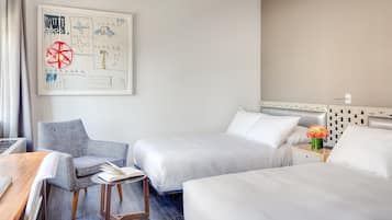 A hotel room with two beds, a desk, a chair, and a wall art piece.