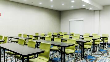 A conference room with tables and chairs arranged for meetings.