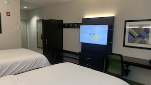 A hotel room with two beds, a desk with a computer, a television displaying a message, and a framed artwork on the wall. - Holiday Inn Express Greenville by IHG (Greenville)