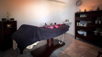 Relax in a serene space with a massage table and a convenient storage cabinet.