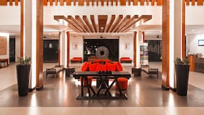 A modern lobby with a central seating area, wooden accents, and a reception desk. - ibis Samui Bophut (Koh Samui)
