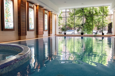 Indoor pool, open 5:00 PM to 9:00 PM, pool loungers. Lions Garden Hotel